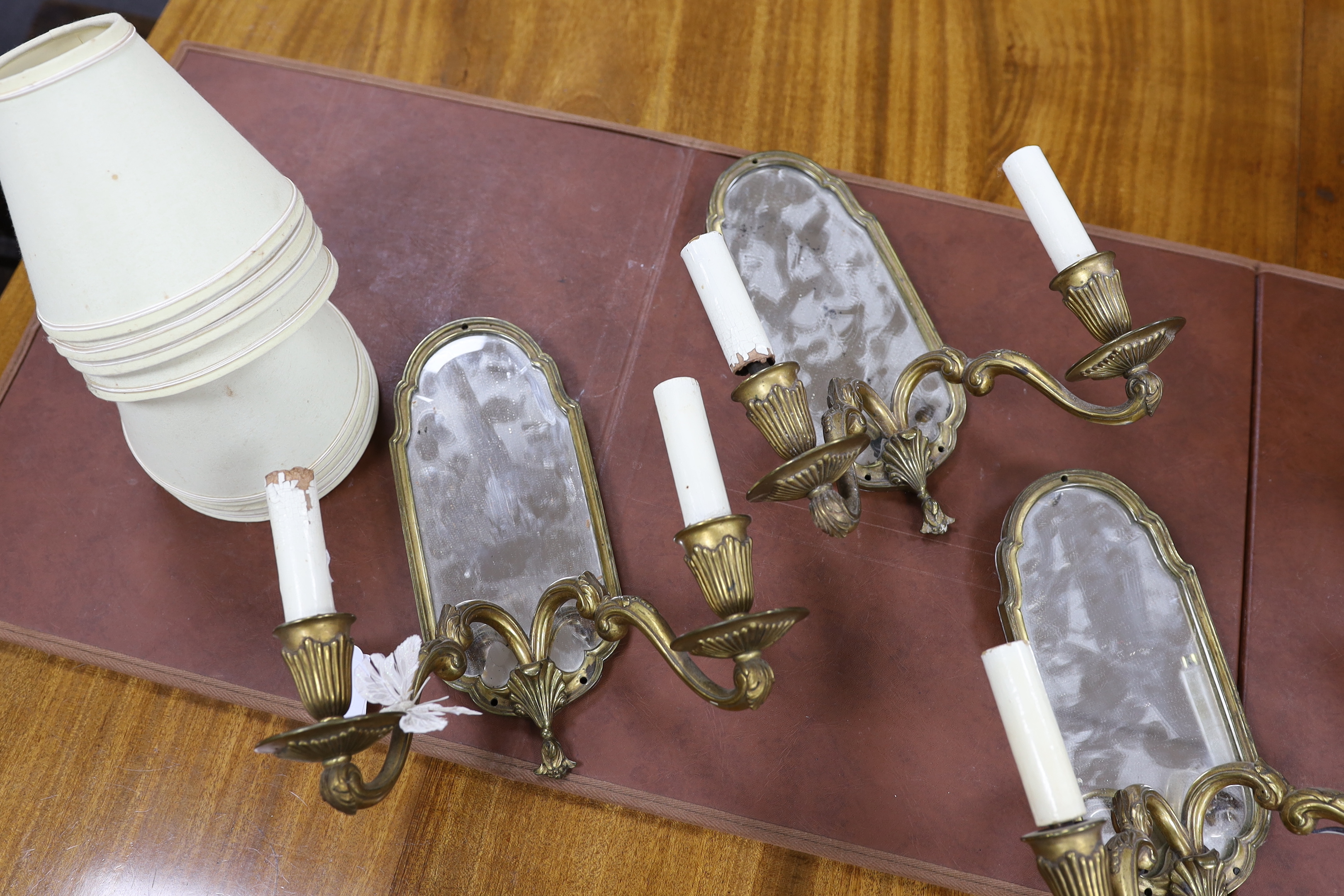 A set of four twin-branch mirror-backed wall sconces, 30cm high